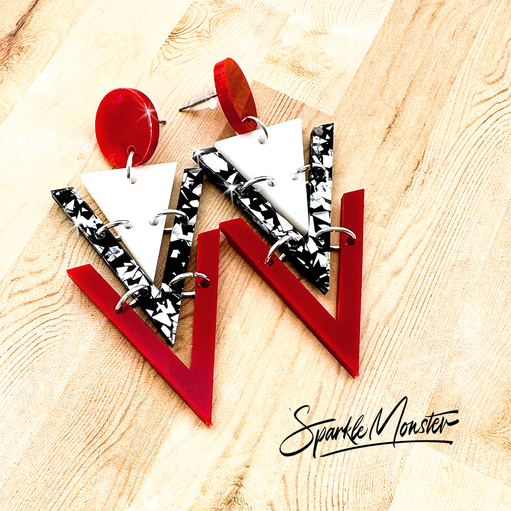 Nagel dangle earrings in red, white, and black