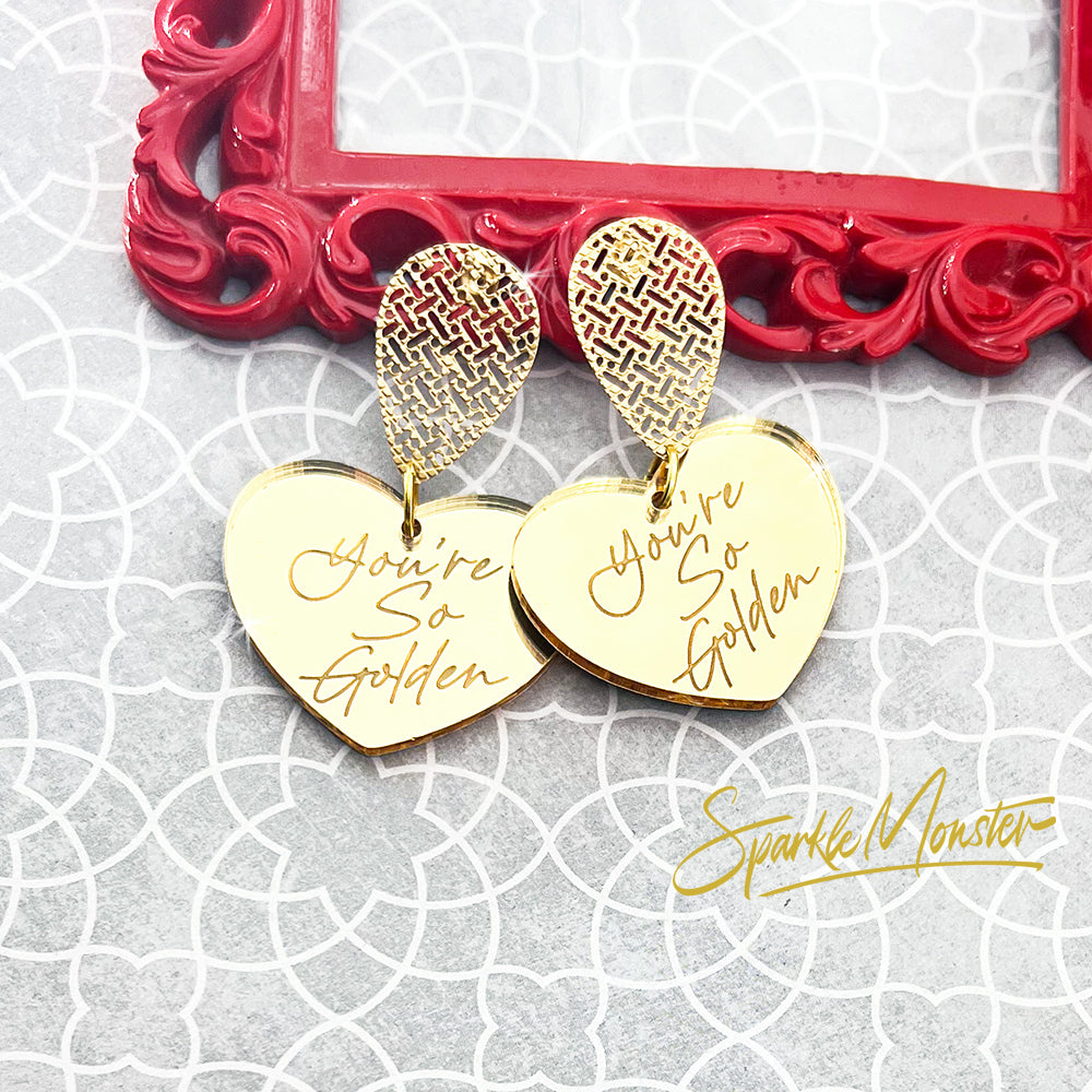 You're So Golden acrylic earrings, heart charms on teardrops, gold mirror, laser cut