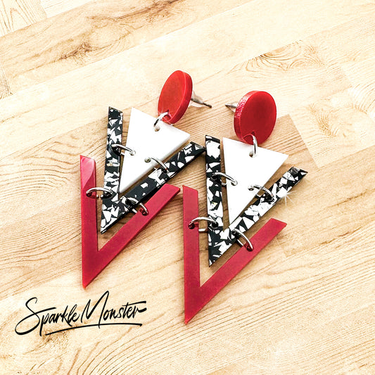 Nagel dangle earrings in red, white, and black