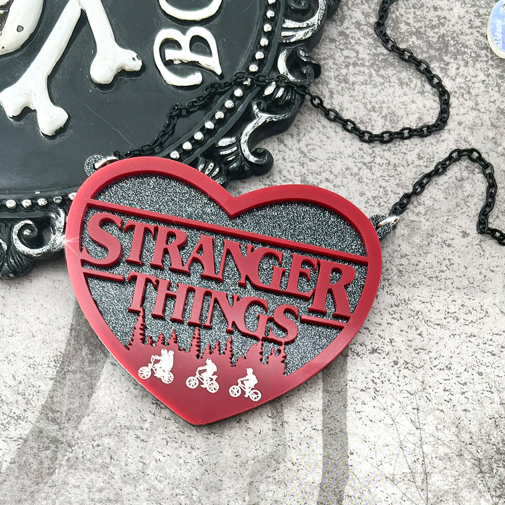 Eleven and the Gang, laser cut acrylic necklace, red on black glitter