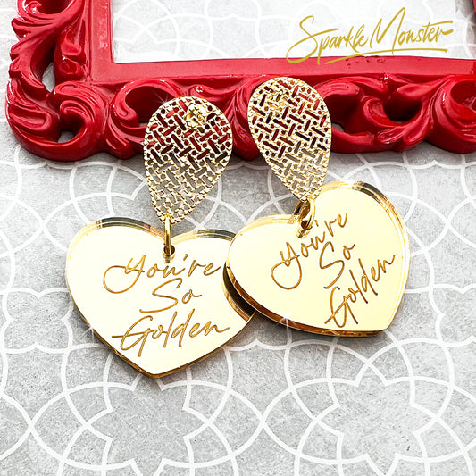 You're So Golden acrylic earrings, heart charms on teardrops, gold mirror, laser cut